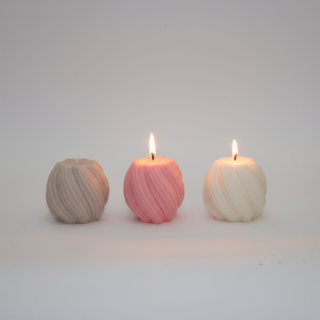 Twisted sphere soy candle on grey concrete surface with white wall background