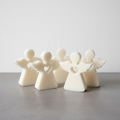 Angel candle collection on grey concrete surface with white wall background