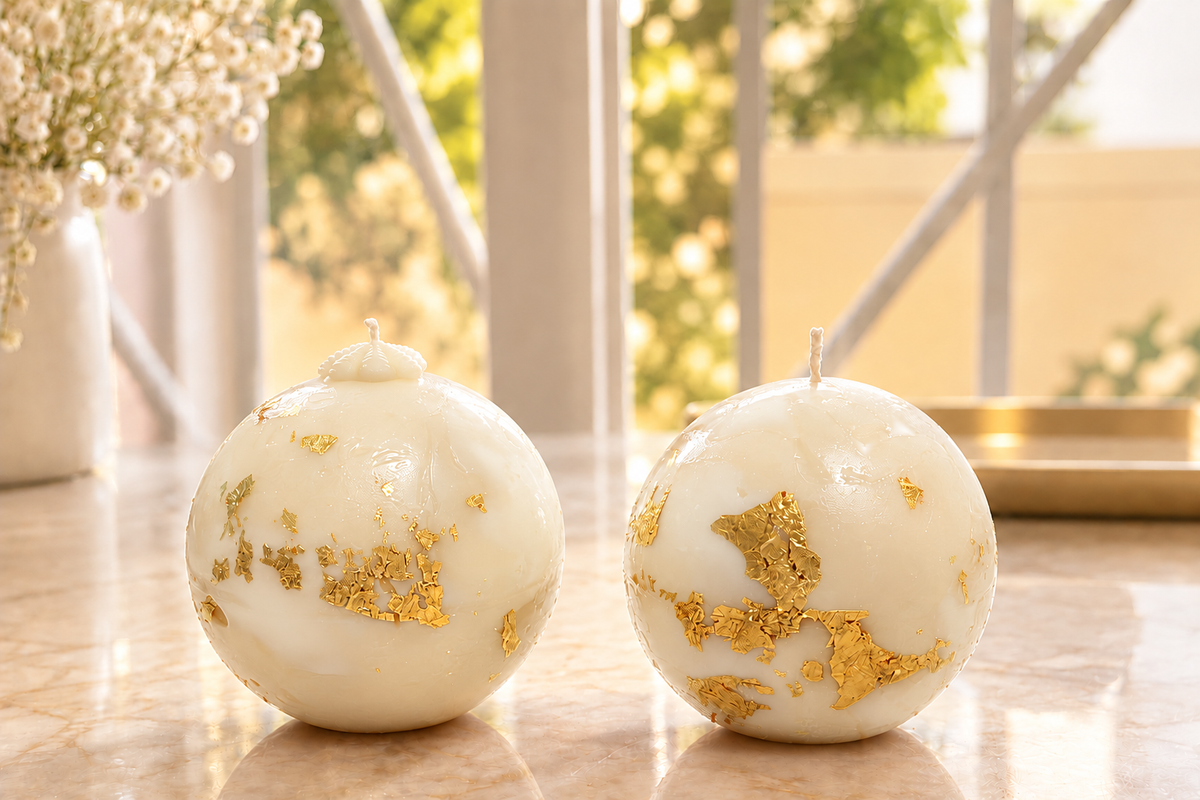 White orb candles with gold leaf
